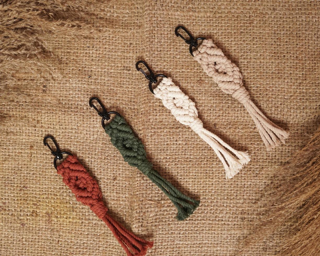 Macrame keychain, Macrame shot, handmade by women at home. Great DIY images for macrame and crafts banners and advertisements. creative hobby layout with accessories, top view. Handcrafted macrame. photo