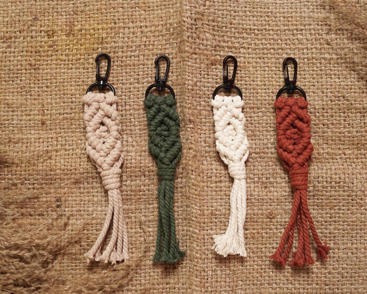 Macrame keychain, Macrame shot, handmade by women at home. Great DIY images for macrame and crafts banners and advertisements. creative hobby layout with accessories, top view. Handcrafted macrame. photo