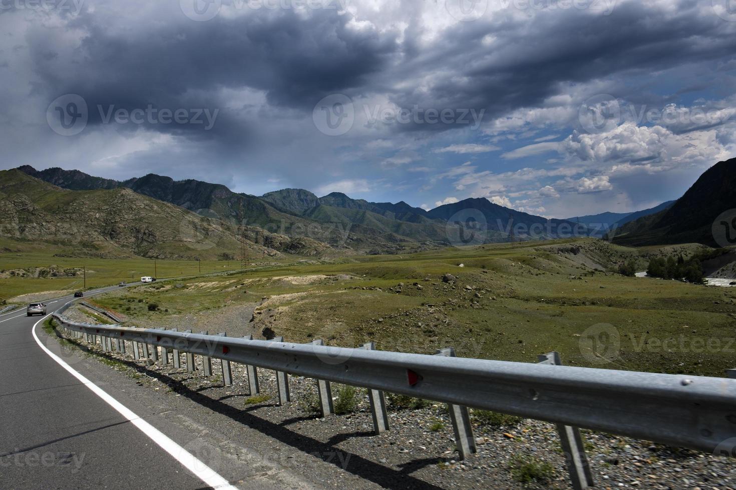 ribbon of the road among the slopes of the mountains on the expanses of Altai on a summer day photo