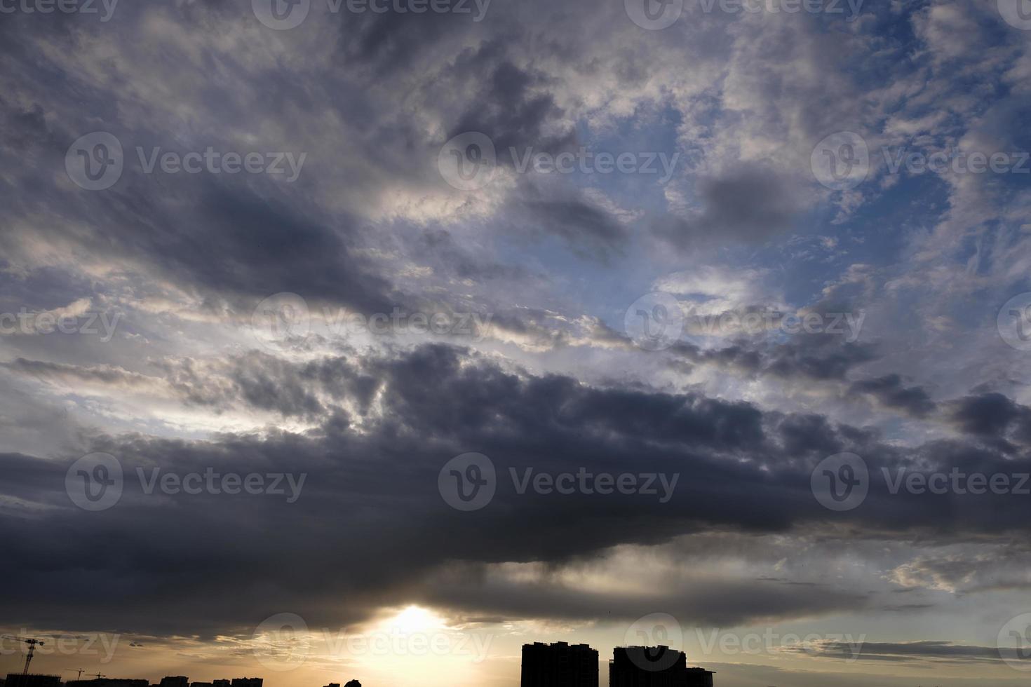 boundless expanse of the sky with cumulus clouds and rays of the sun, moments of daybreak and sunset photo