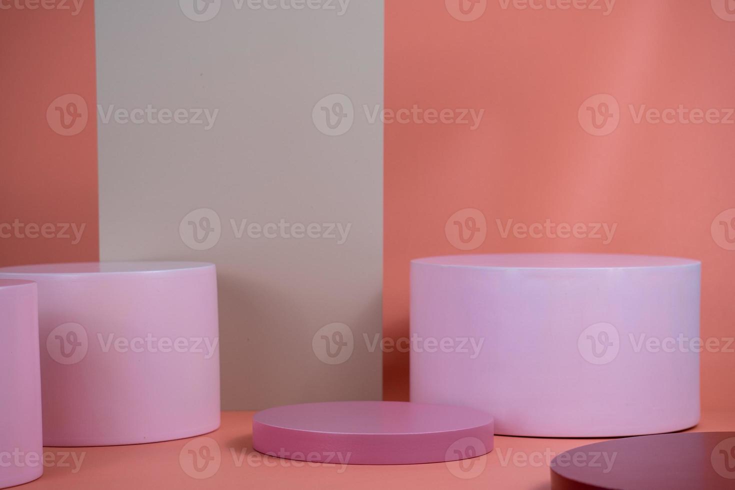 Empty podium for display cosmetic product. Platform arrangement in pink pastel color in trendy minimalist style. Composition of cylinders and cubes layout for feminine background photo