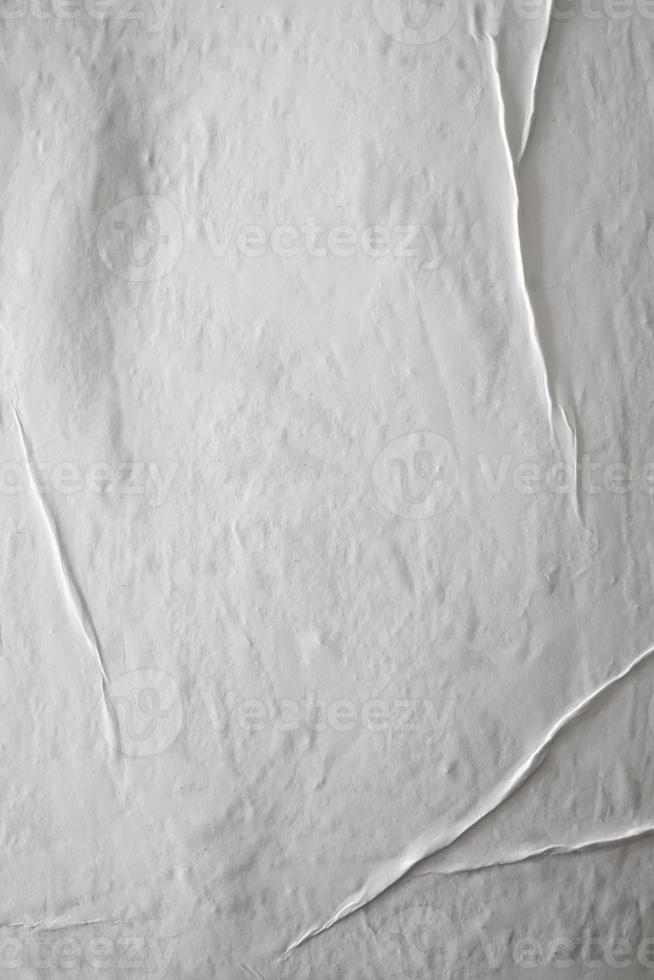 Blank white glued paper for poster texture overlay. Crumpled and wrinkled pattern for background. Matted wet paper for mockup posters, flyer,  brochure, and banner design photo