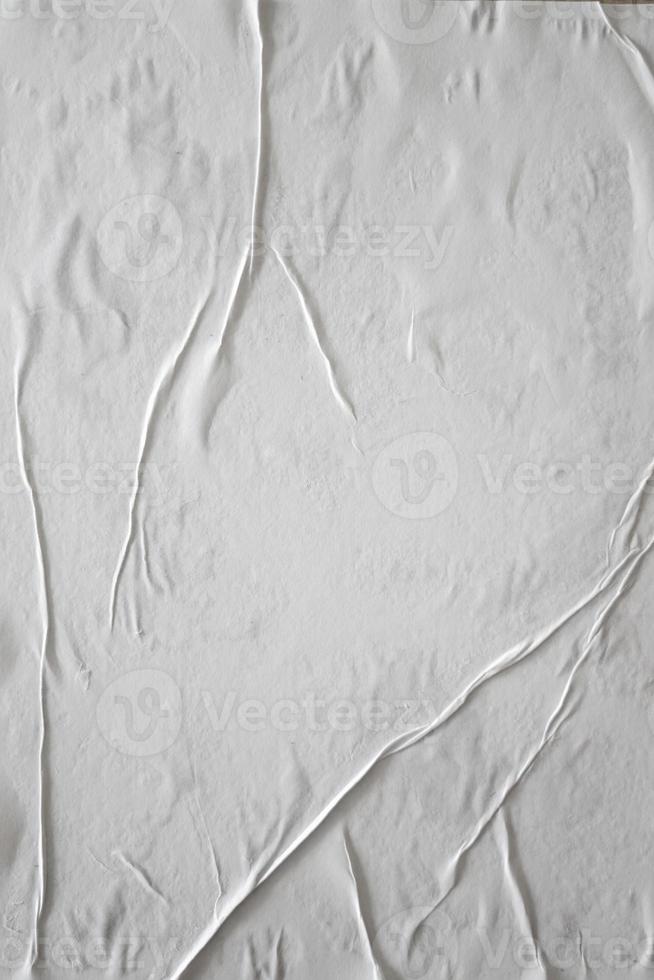 Blank white glued paper for poster texture overlay. Crumpled and wrinkled pattern for background. Matted wet paper for mockup posters, flyer,  brochure, and banner design photo