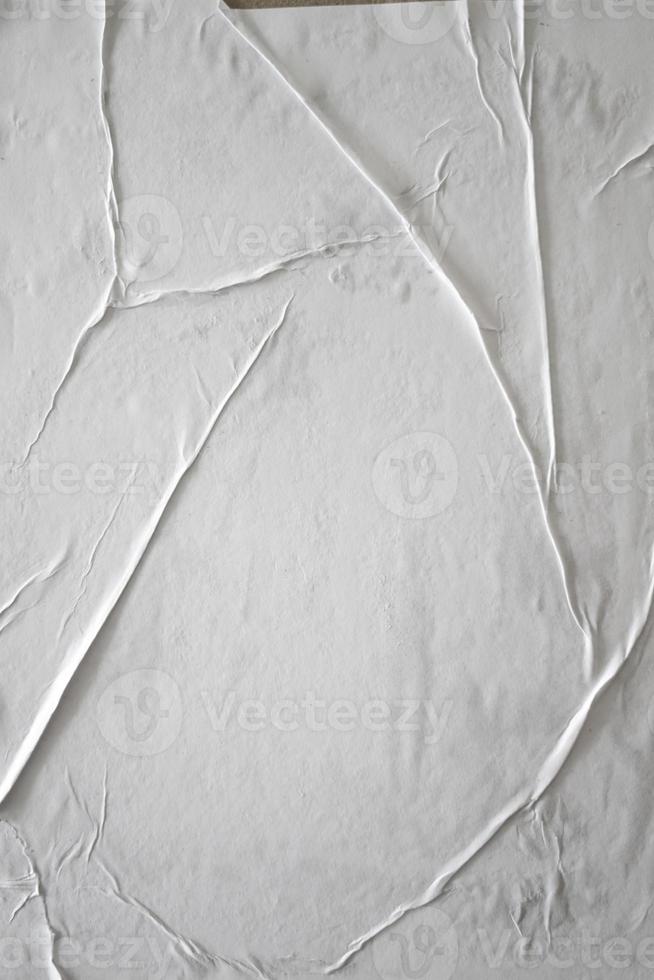 Blank white glued paper for poster texture overlay. Crumpled and wrinkled pattern for background. Matted wet paper for mockup posters, flyer,  brochure, and banner design photo