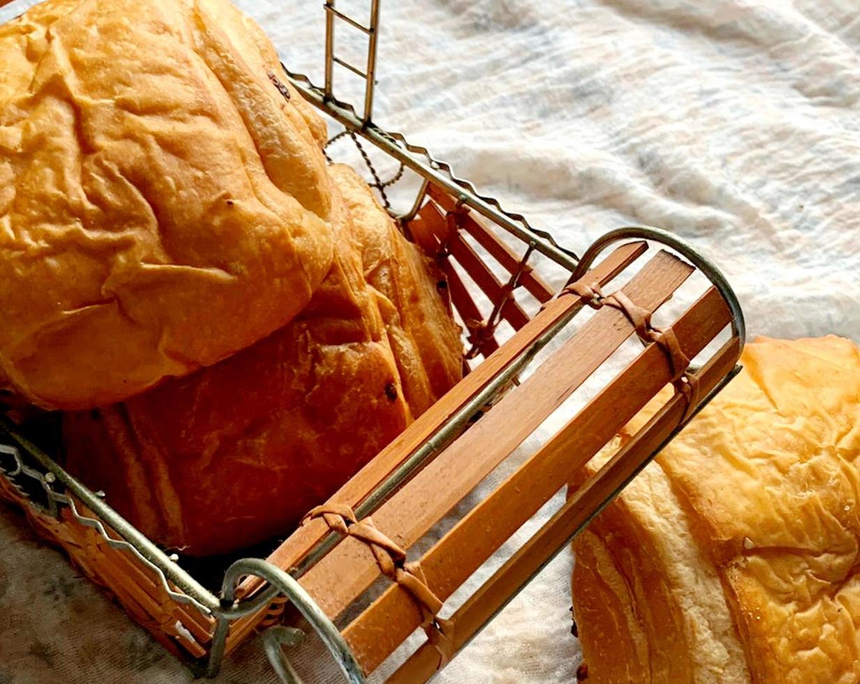 Fresh patty pieces placed next to a wooden rolling pin to spread the pastries photo