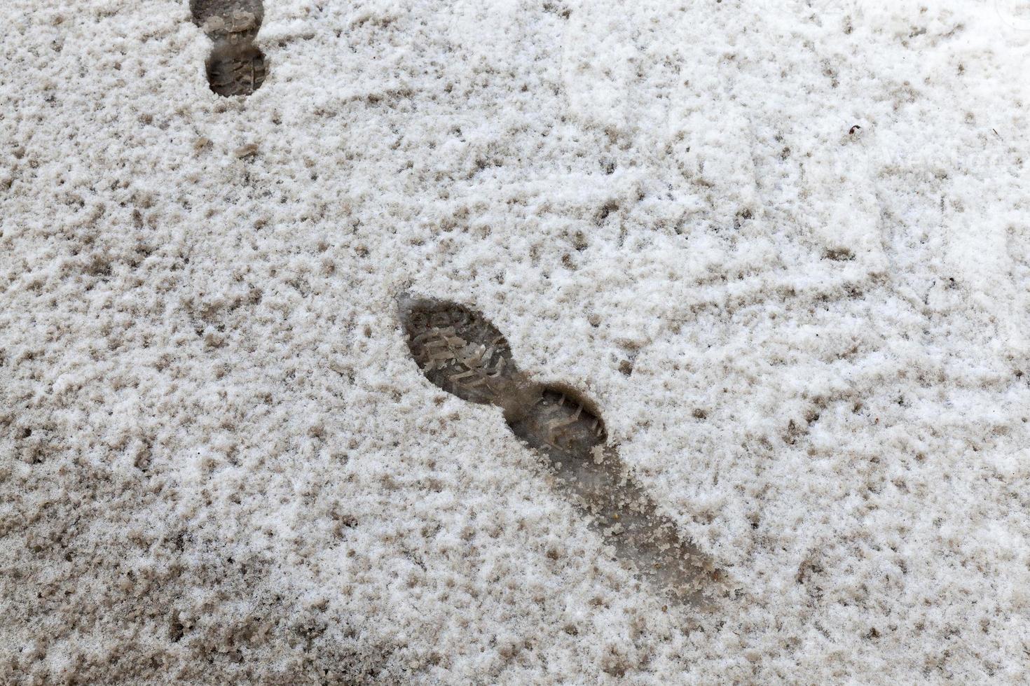 Traces on dirty snow photo