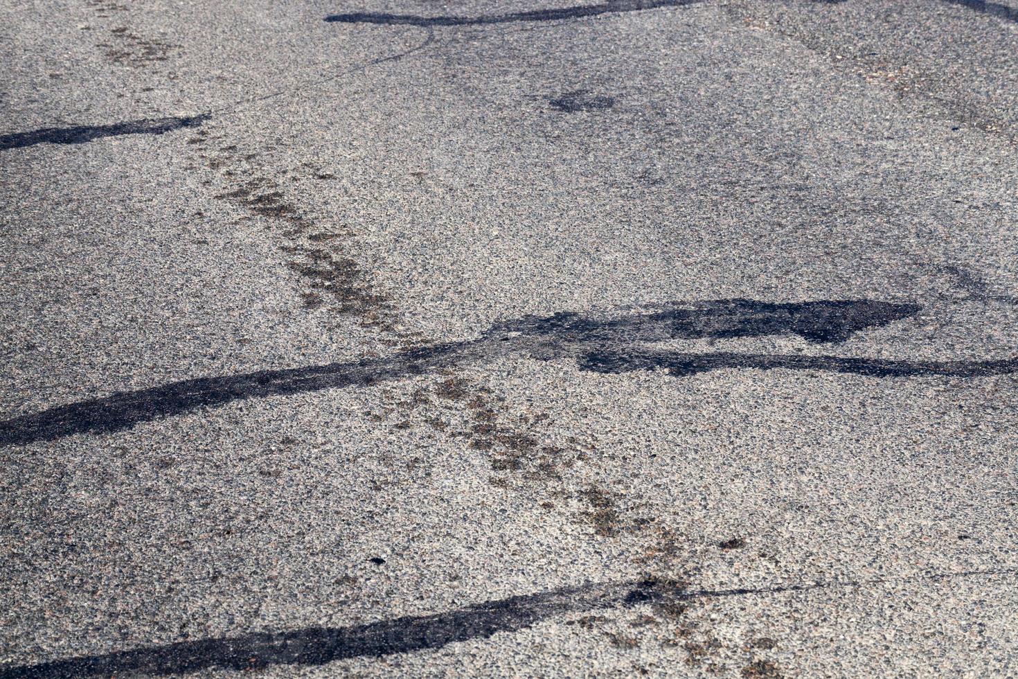 part of an asphalt road with damage photo