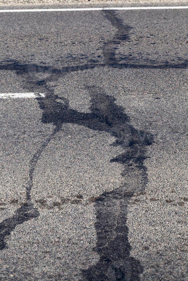 part of an asphalt road with damage photo