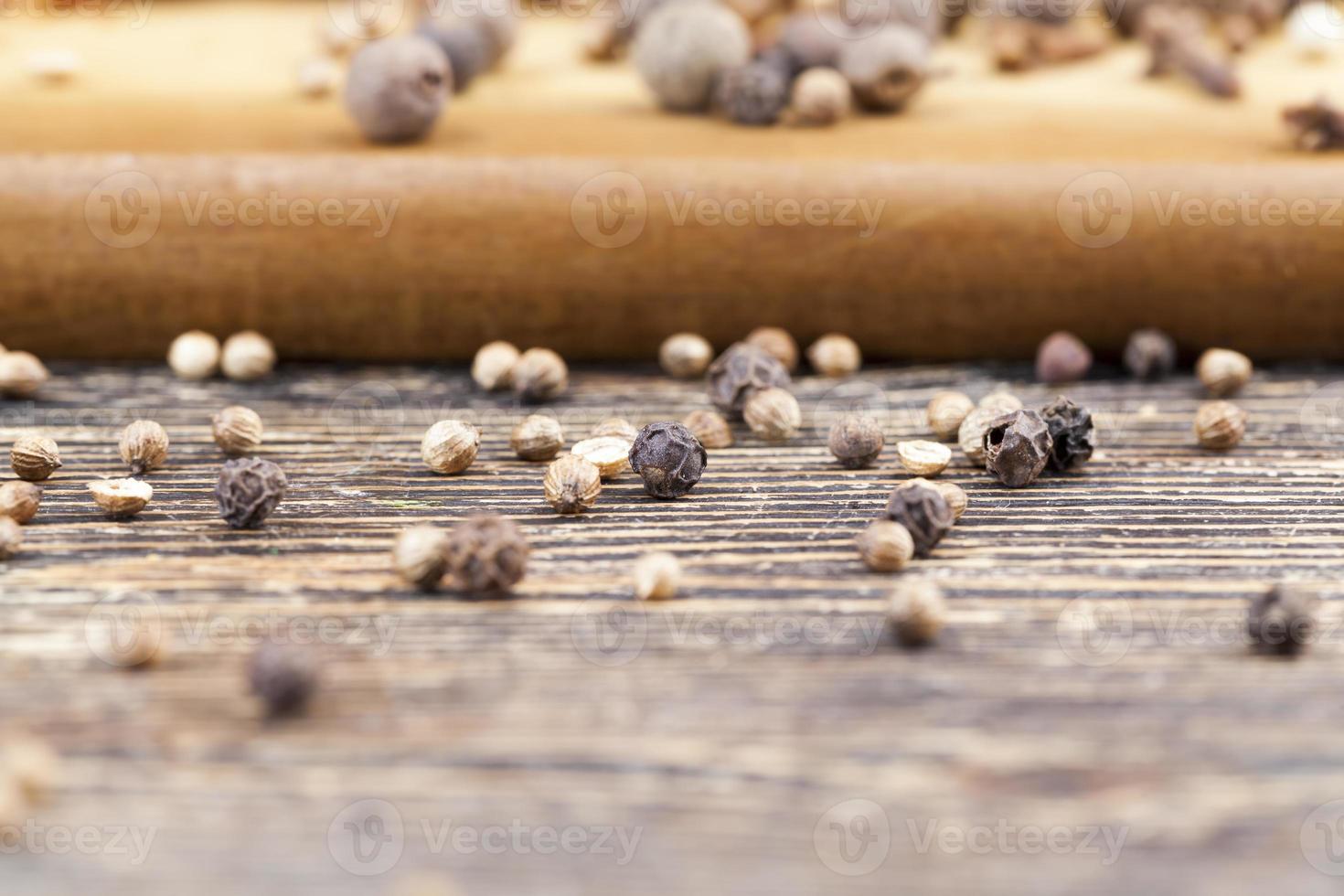 coarse salt and whole pepper spices on the table photo