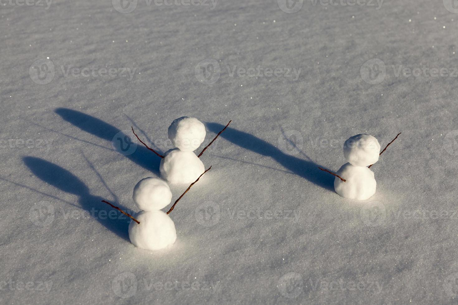 games in the snow with the creation of several snowman figures photo