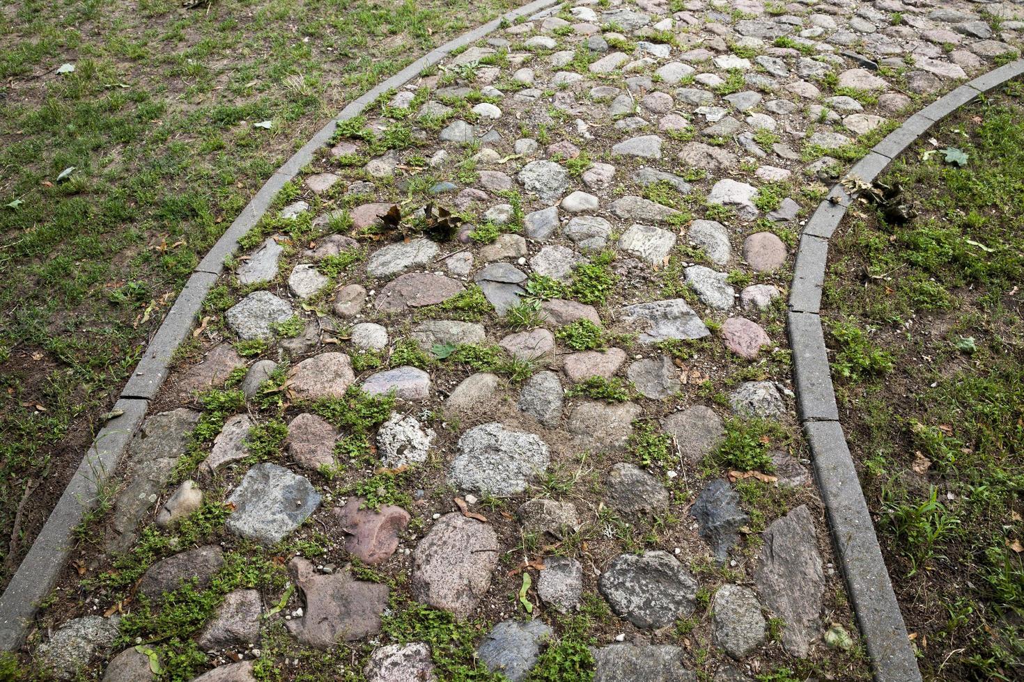 the old road is made of stones and cobblestones photo