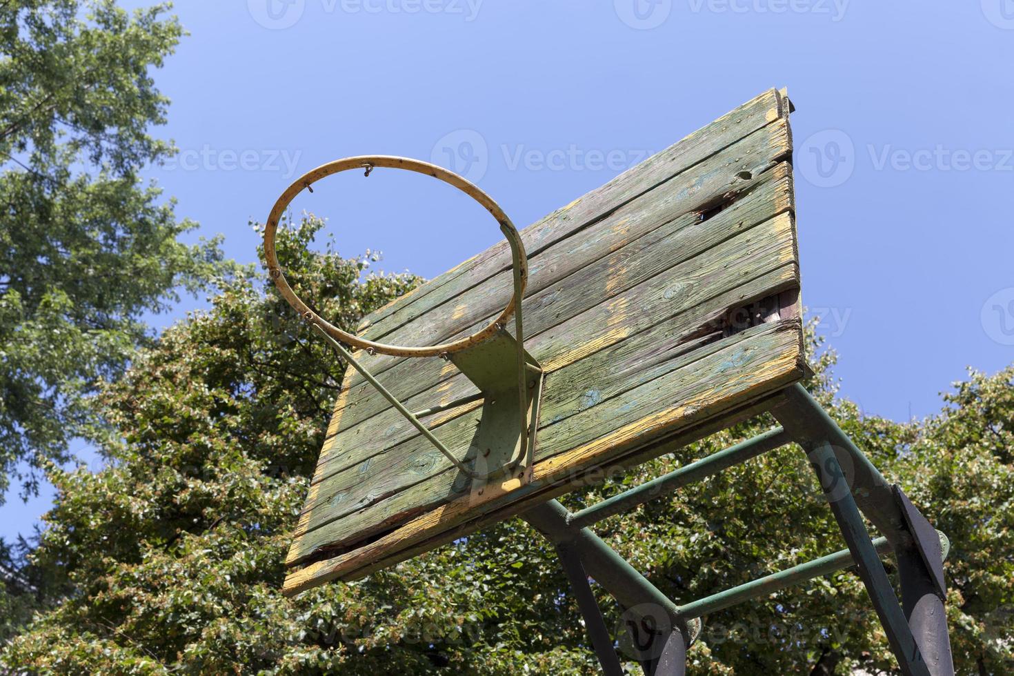 an old basketball ring in the yard photo