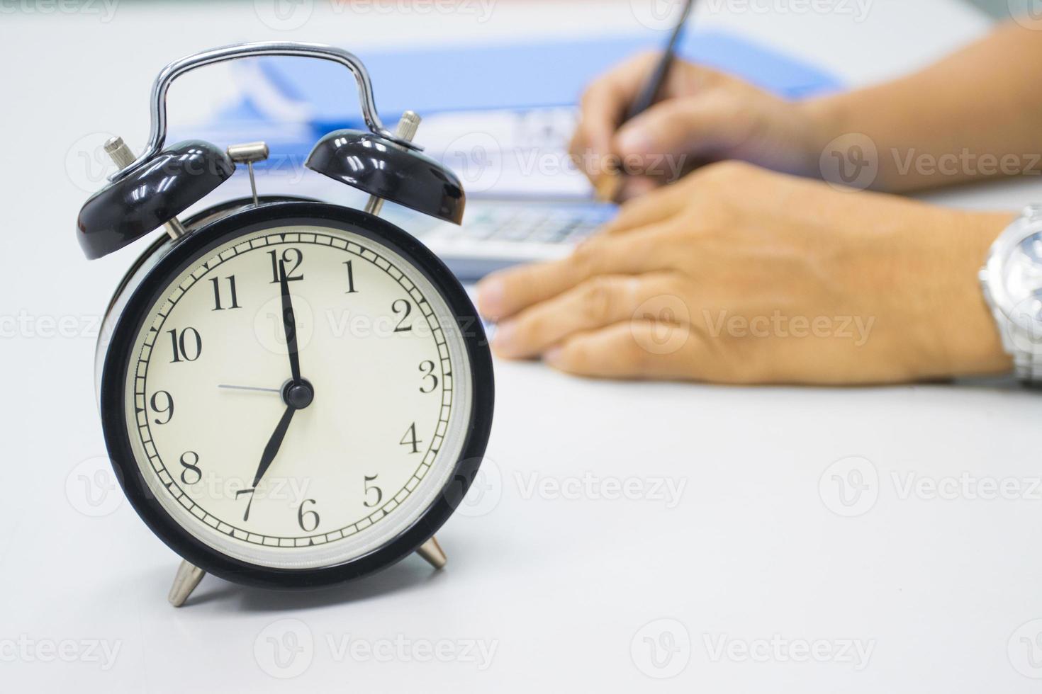 7 AM Clock on work desk in the office Time of businessman working concepts selective clock photo