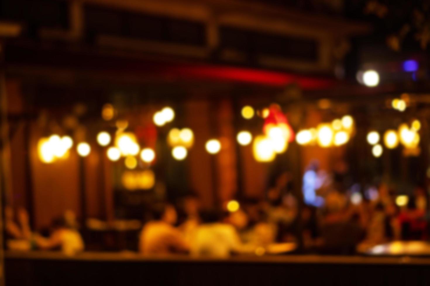 blurred image at the restaurant night time, many people in the restaurant eat and party happy relaxing photo