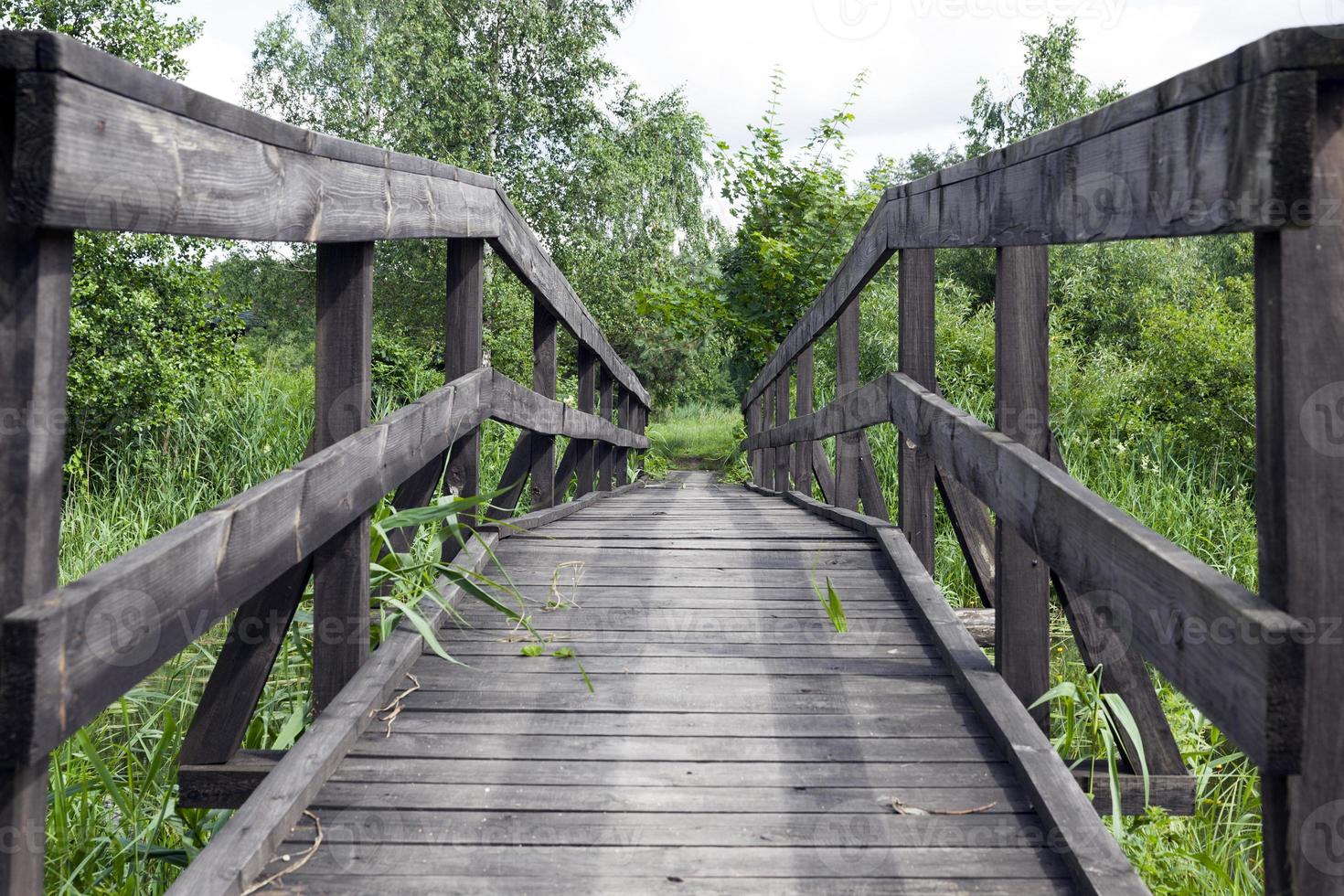 old wooden bridge built on the lake photo