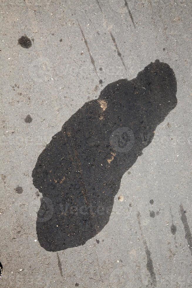 car oil stains on an asphalt road photo