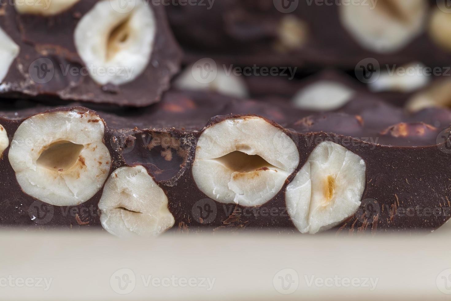 milk chocolate with whole and chunks of hazelnuts photo