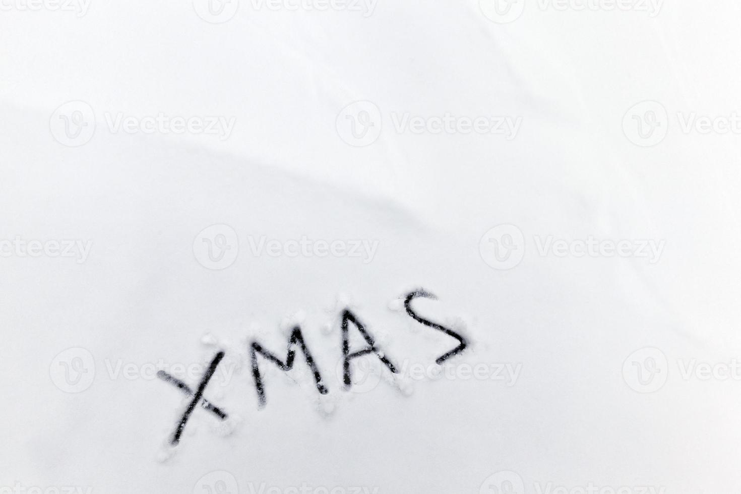 words xmas painted on snow photo