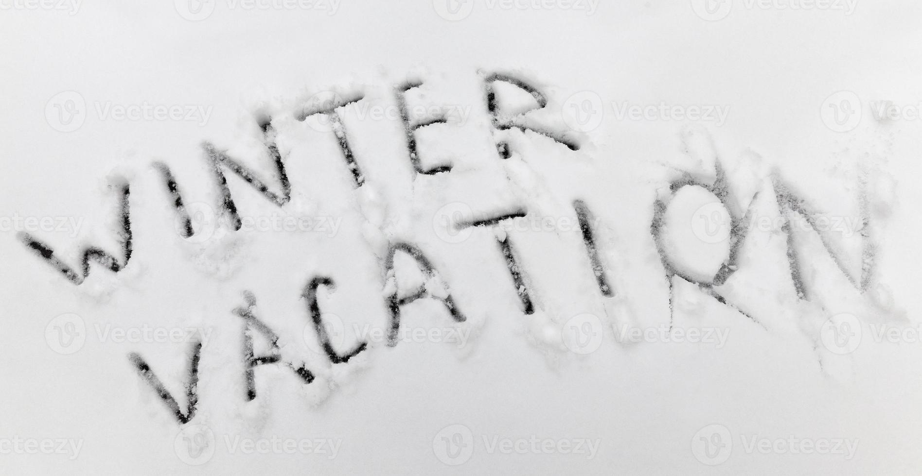 words winter holidays drawn on snow photo