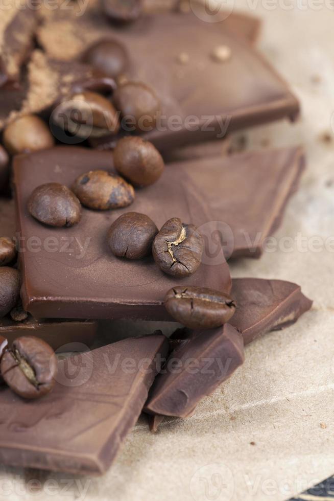 chocolate bar with cocoa powder topping and coffee beans photo