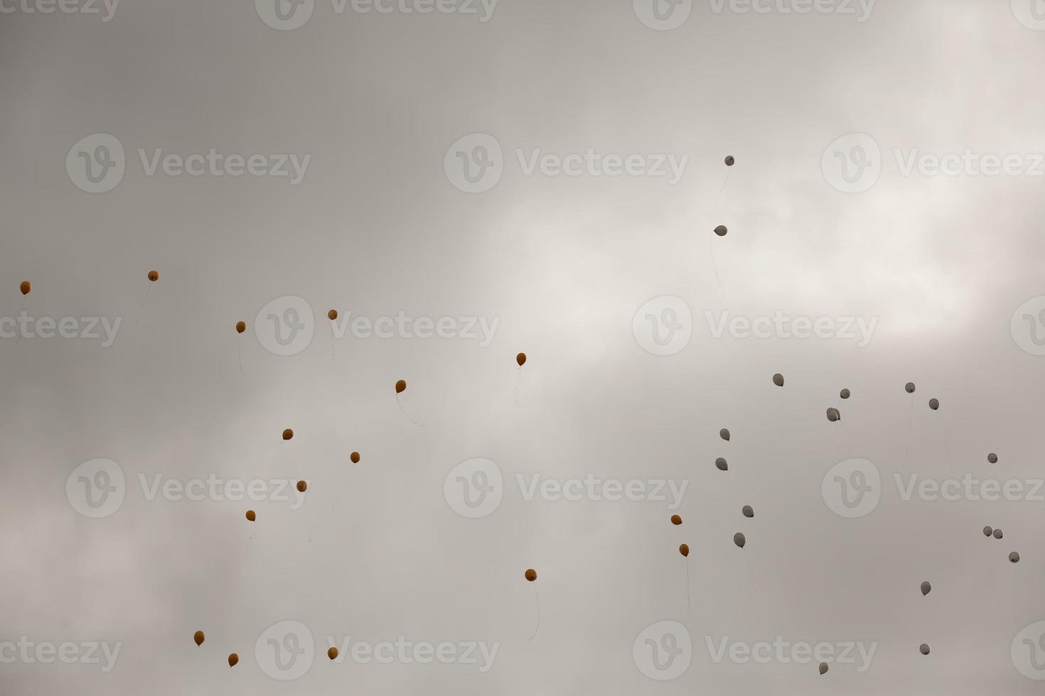 balloons with helium in sky photo
