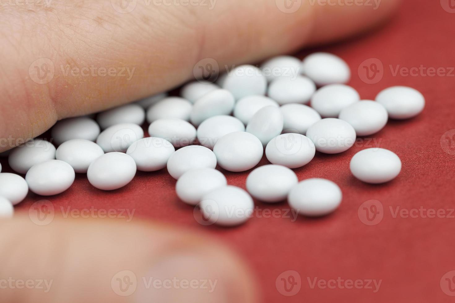 in the hand of a person and scattered on a red background photo