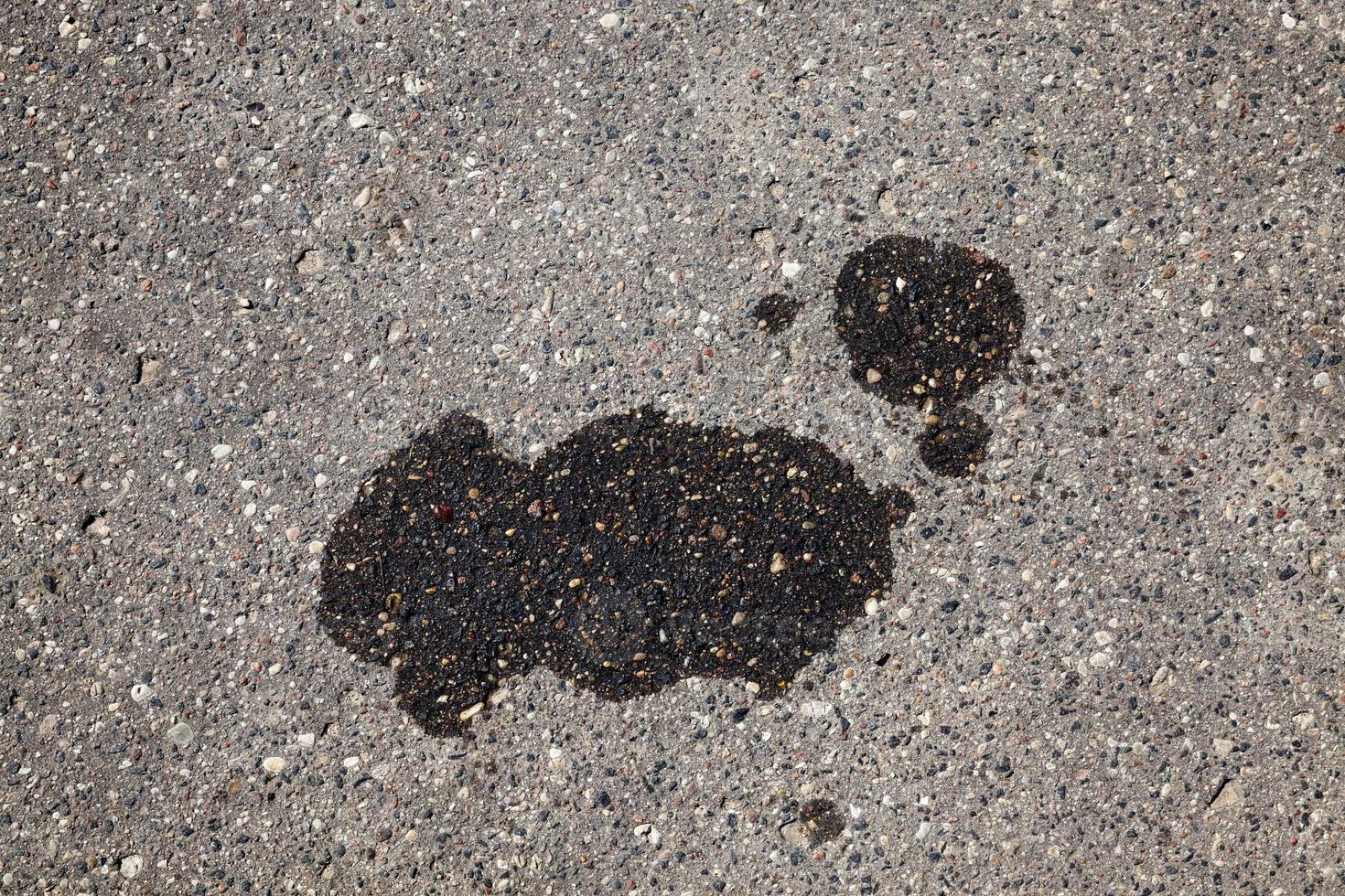 manchas de aceite de coche en una carretera asfaltada foto