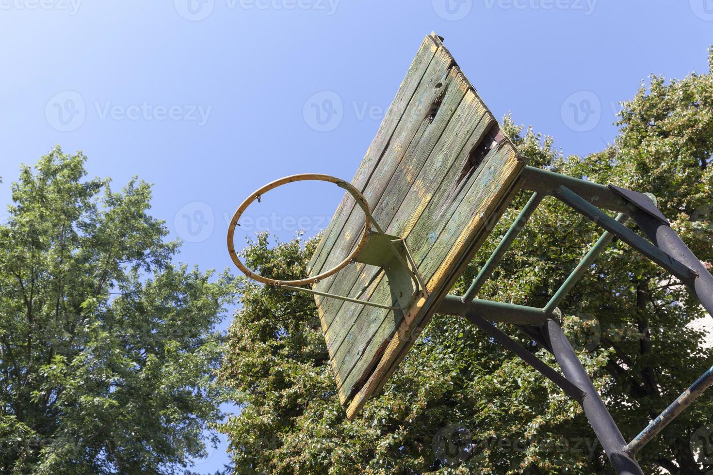 an old basketball ring in the yard photo