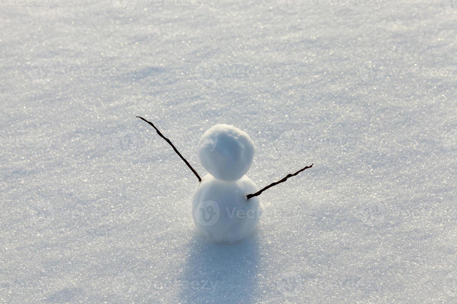 one small snowman in the winter season, close up photo