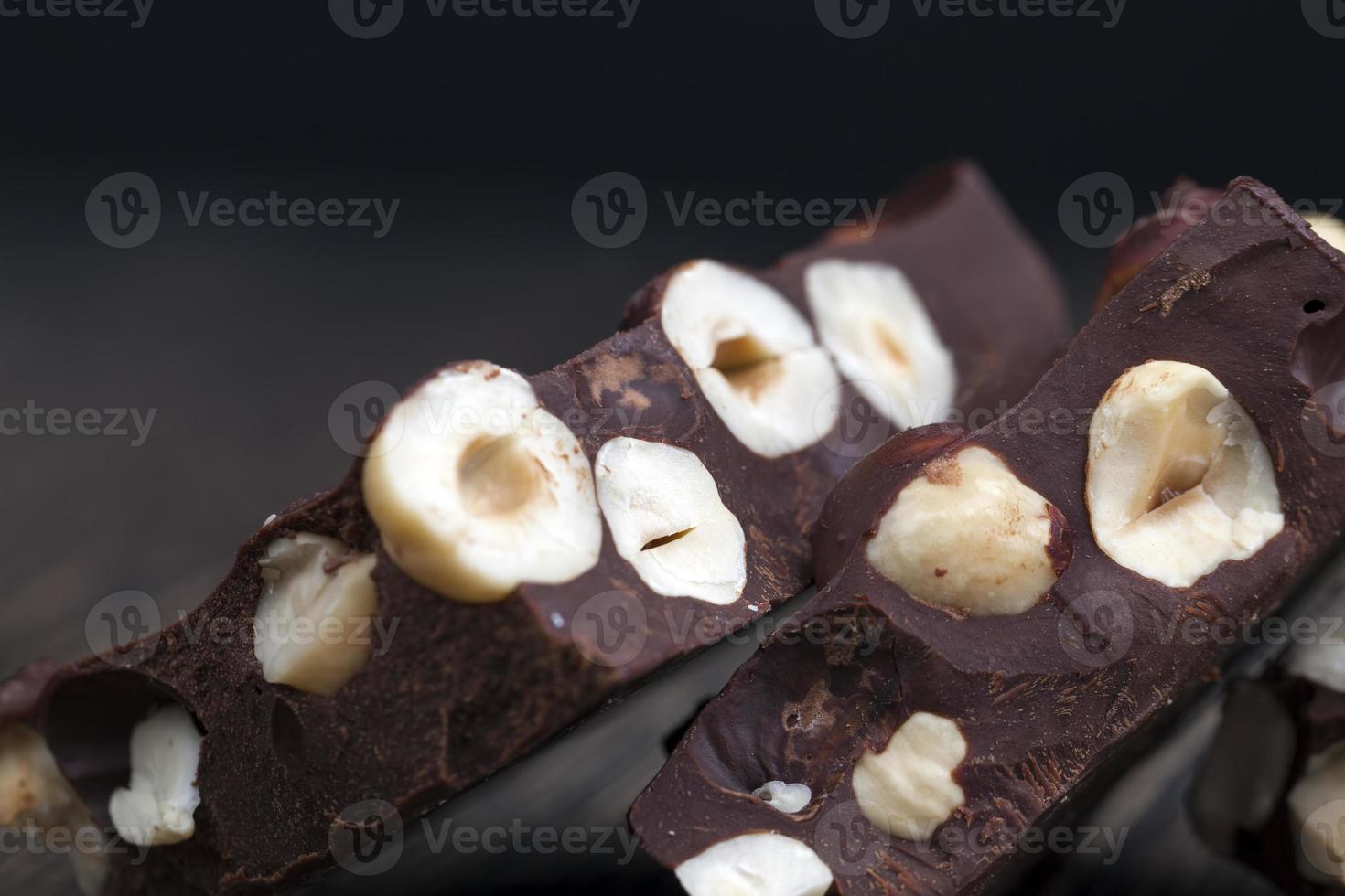 milk chocolate with whole and chunks of hazelnuts photo