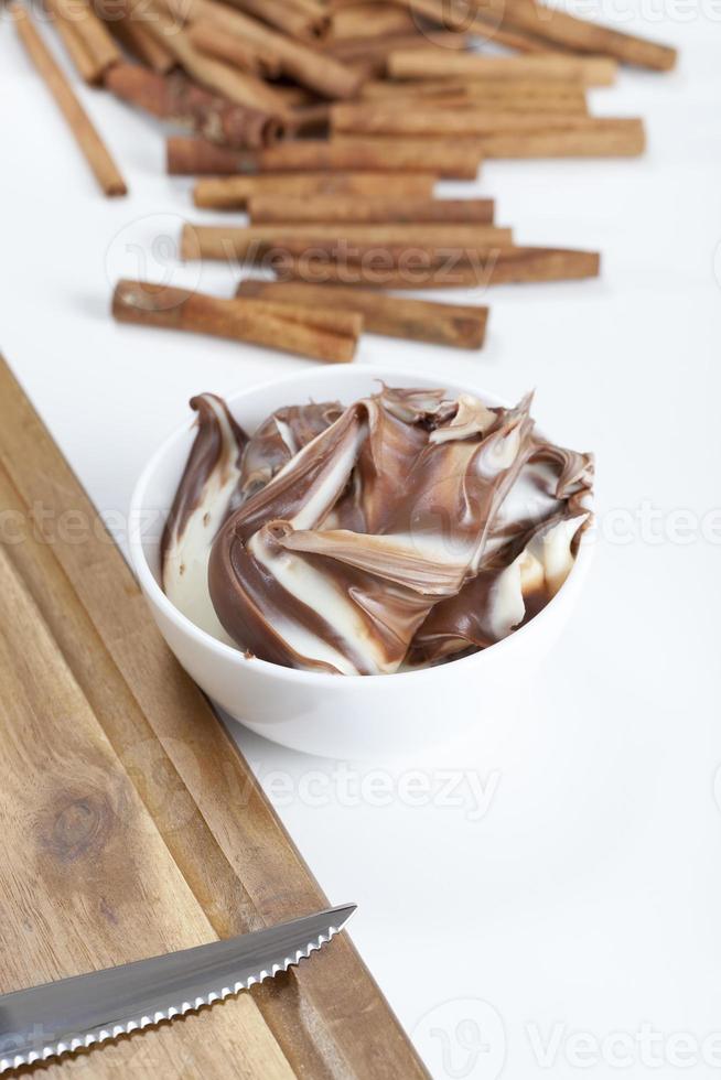 sliced white bread with smeared chocolate butter photo