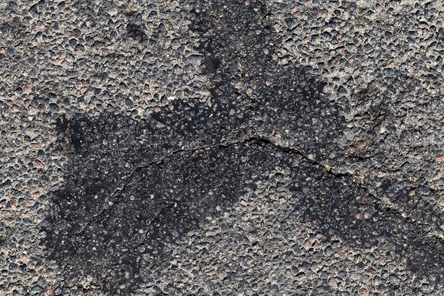 part of an asphalt road with damage photo