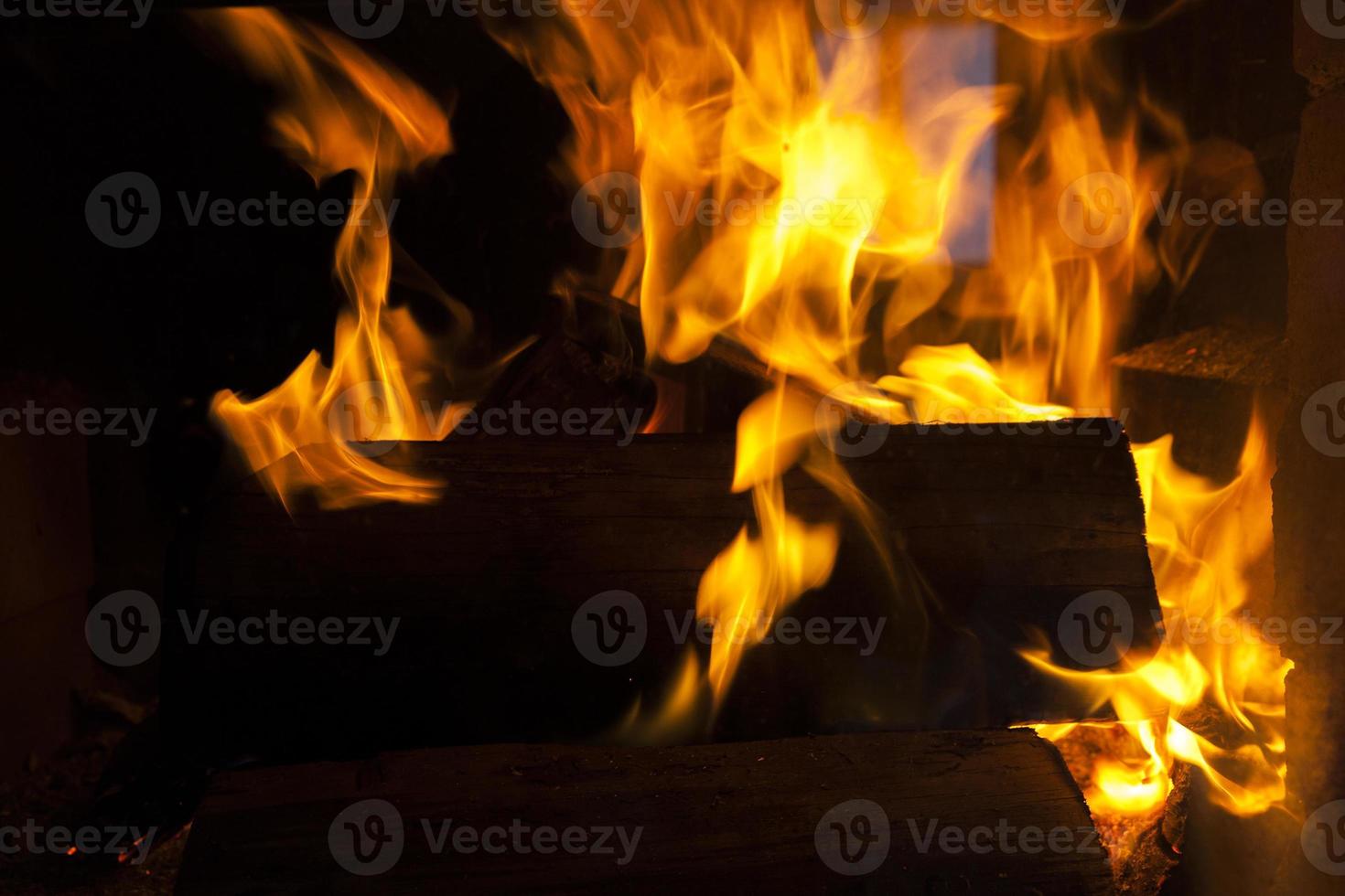 burning logs in the fire of a barbecue or stove or fireplace 9718416