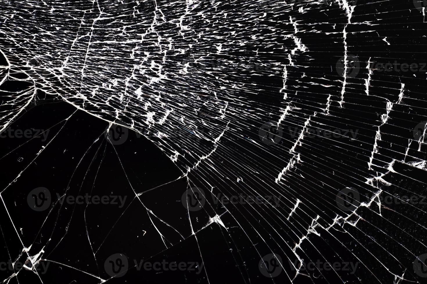 broken thin glass with lots of cracks photo