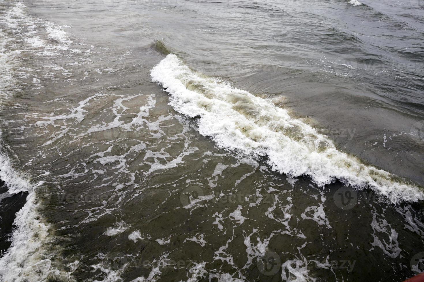 sea coast with lots of waves from windy weather photo