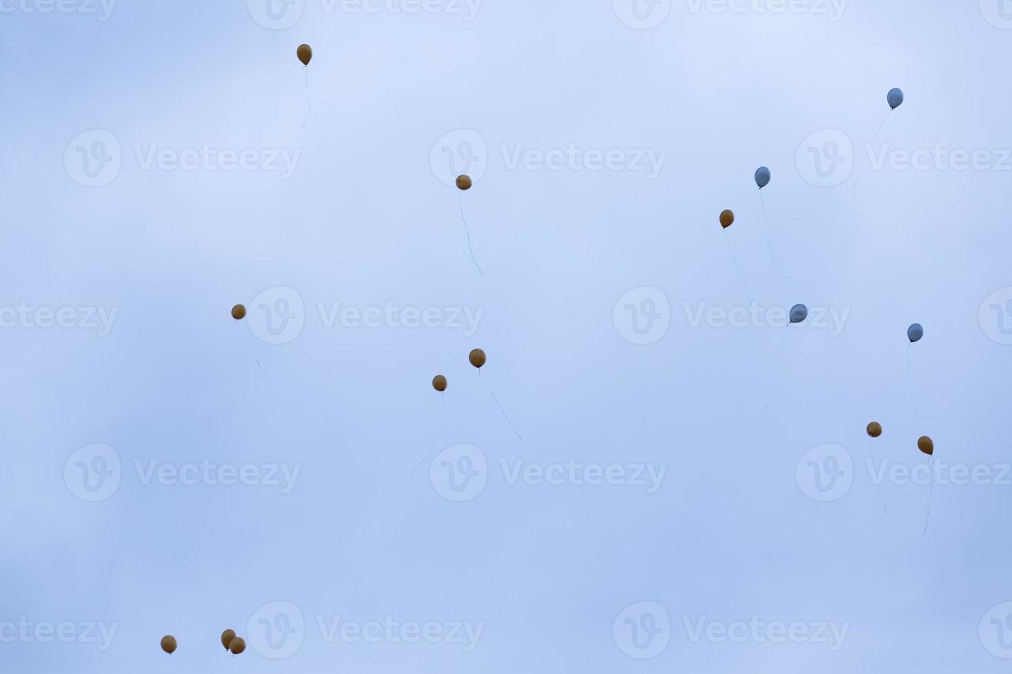 balloons with helium in sky photo