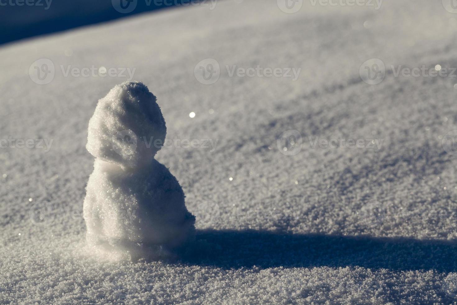 one small snowman in the winter season, close up photo