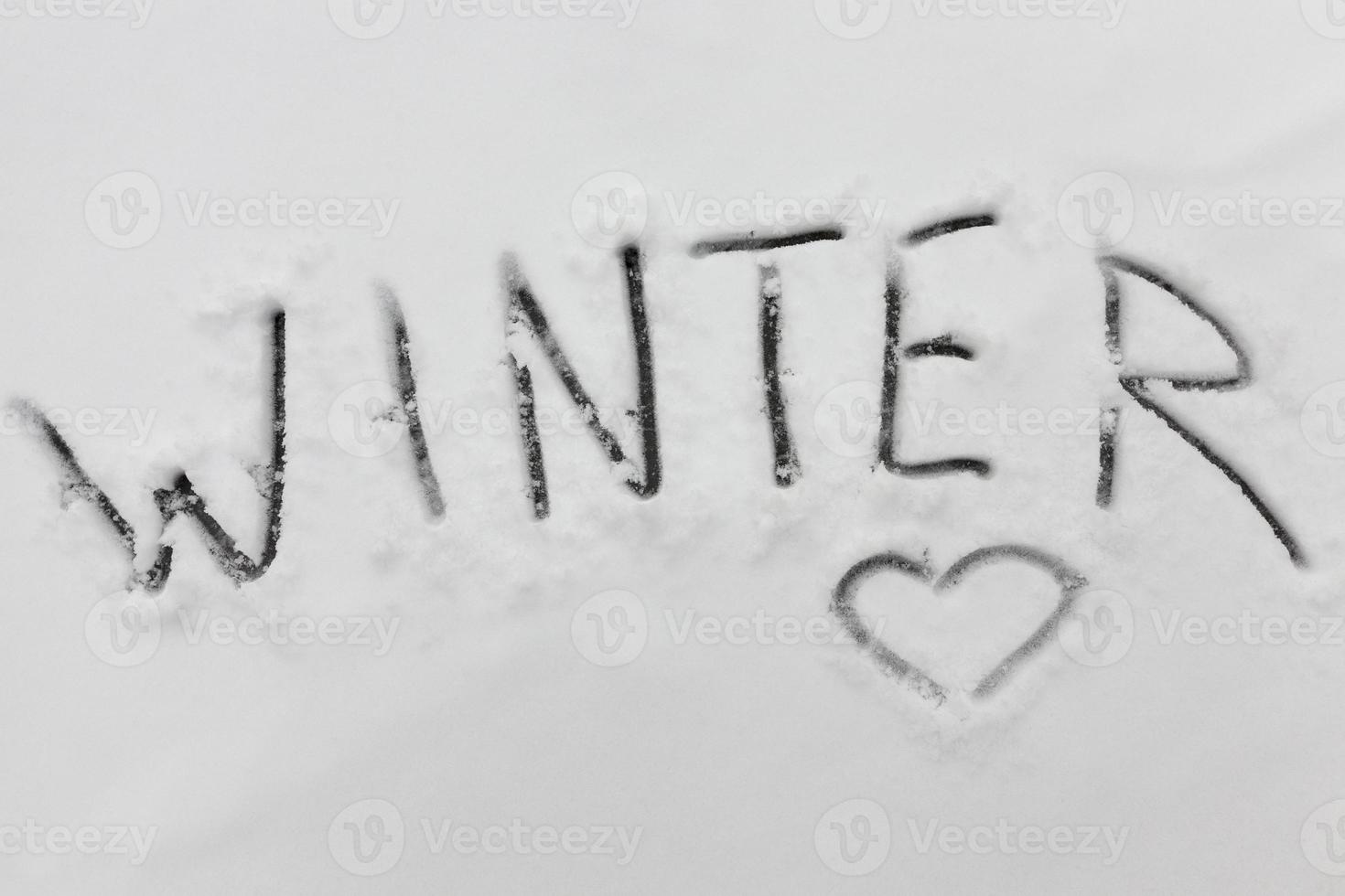 the word winter on the snow in the winter season photo