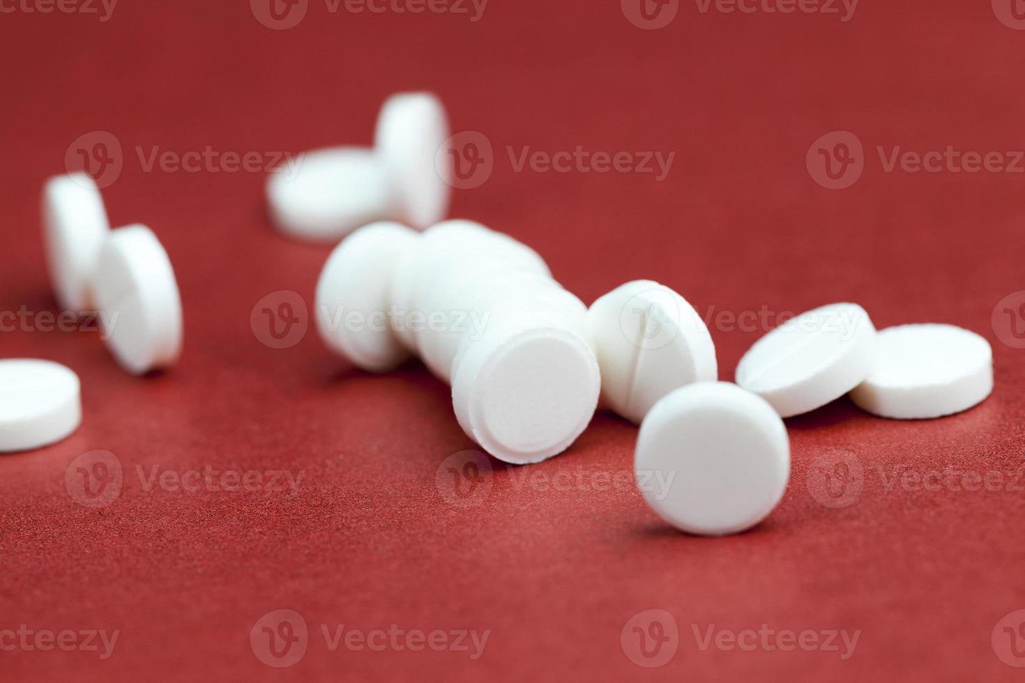 medicines for the treatment of diseases scattered on a red background photo