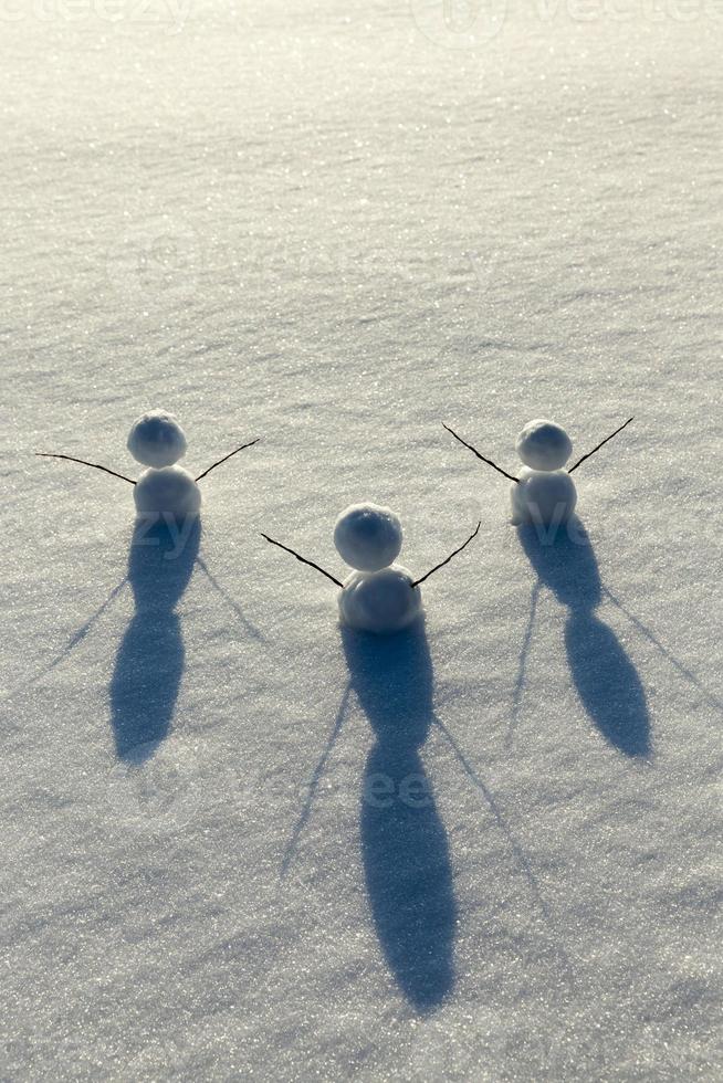 games in the snow with the creation of several snowman figures photo