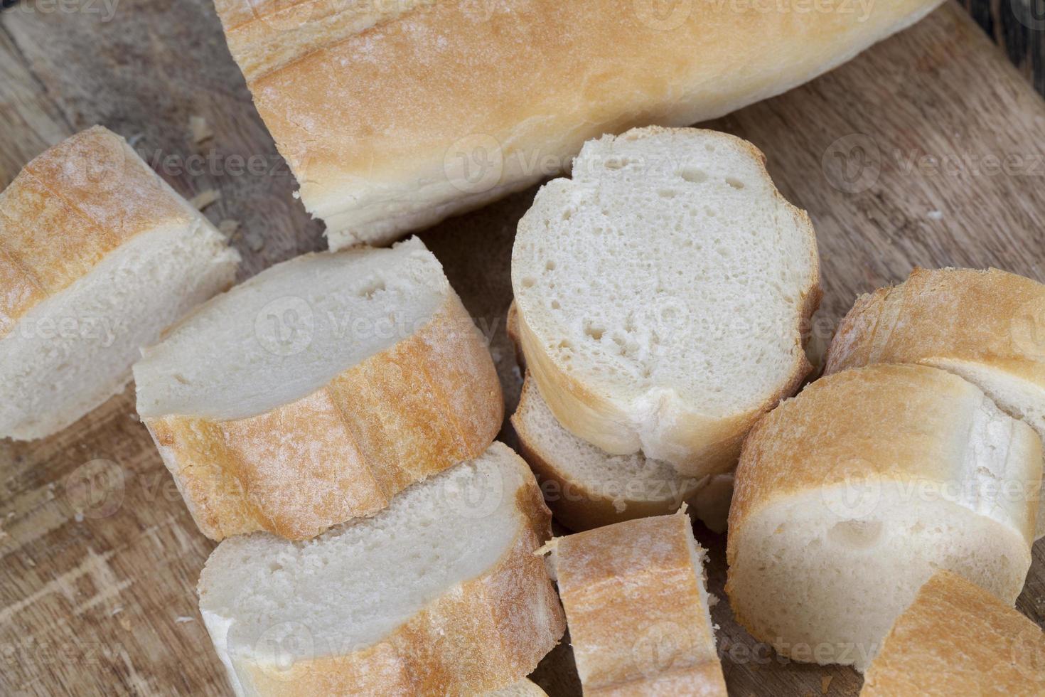 loaf of wheat baguette cut into slices photo