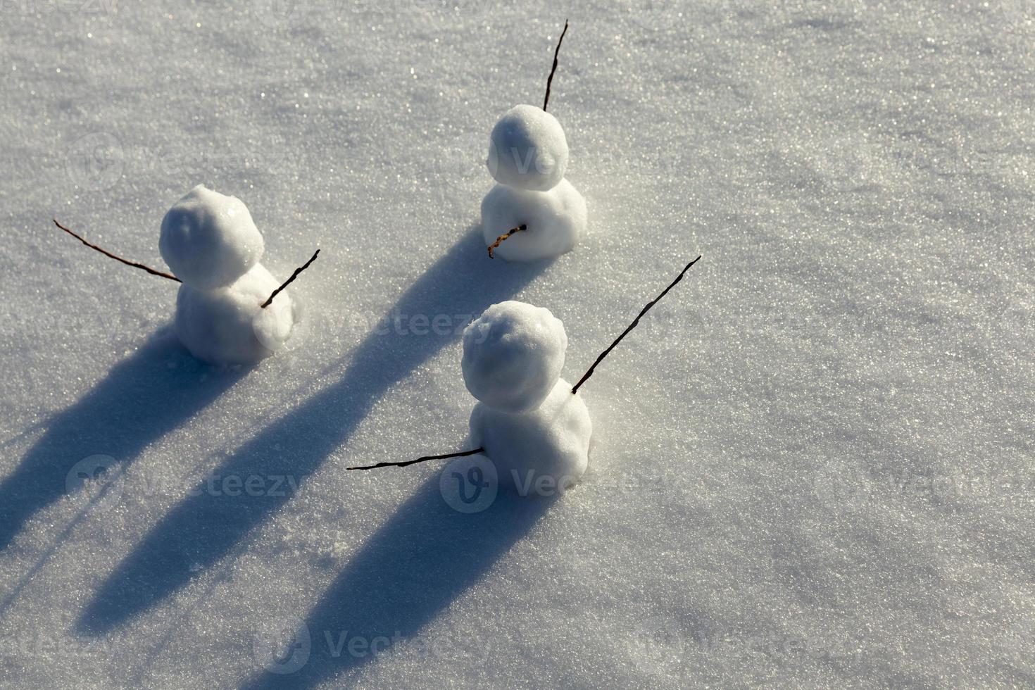 games in the snow with the creation of several snowman figures photo