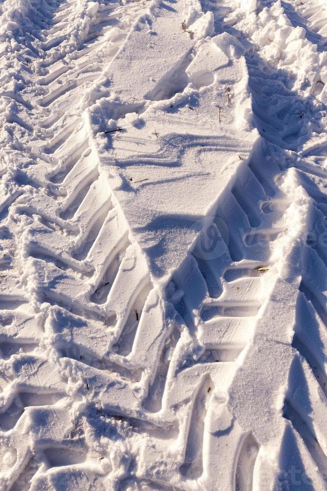 Traces of the car on the snow photo