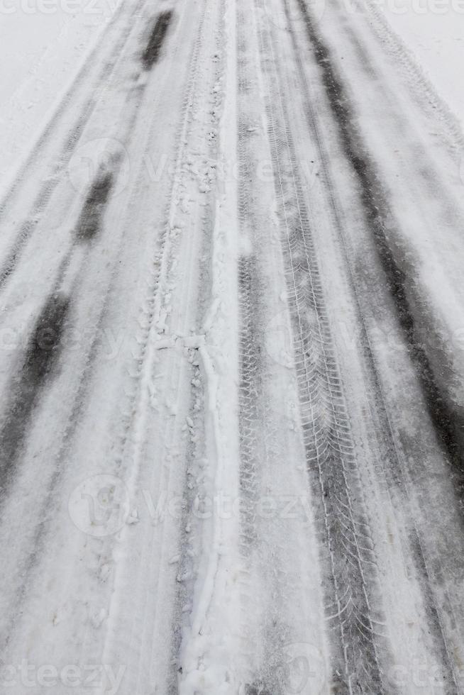 Snow drifts in winter road photo