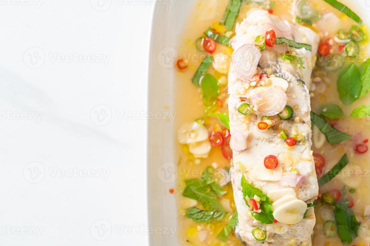 steamed sea bass fish with herbs photo