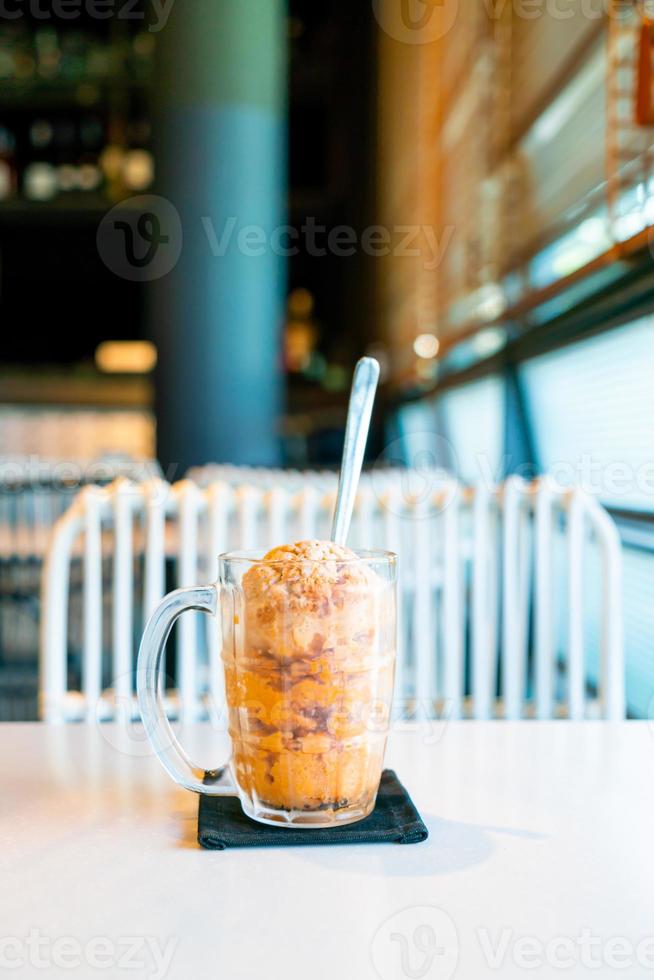 Thai tea ice scoop in glass photo