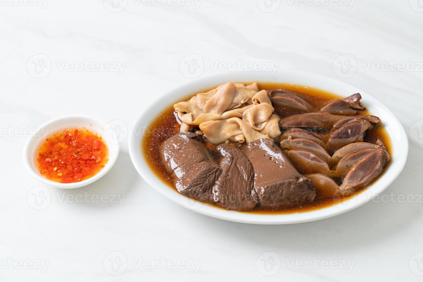 stewed duck offal in brown soup photo