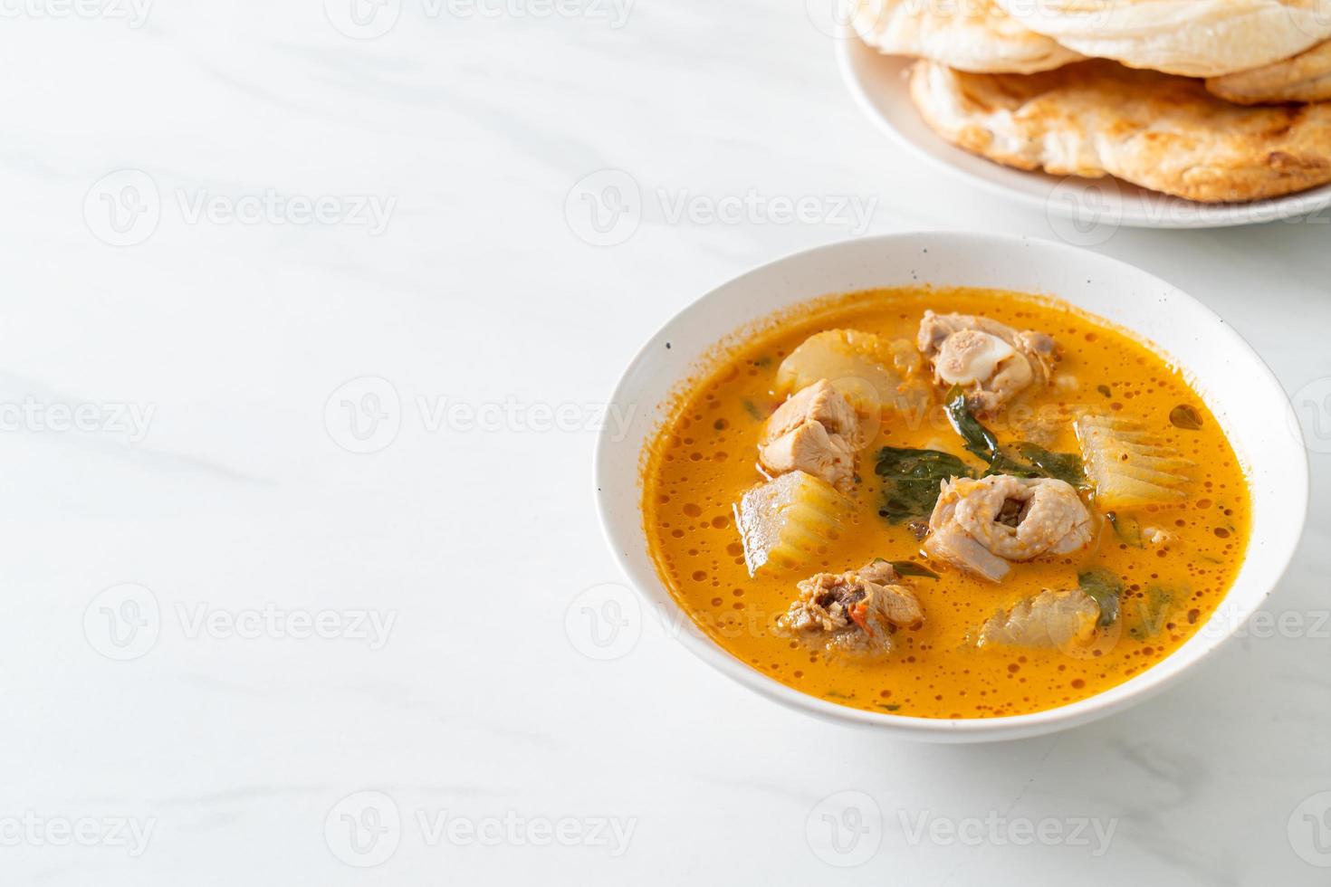 Chicken curry soup with roti photo