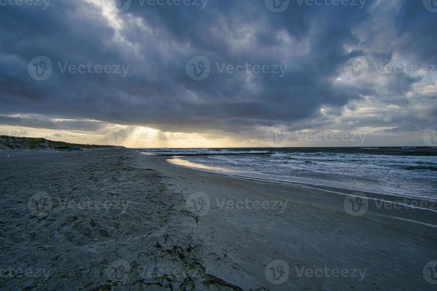 View over the dunes to the Baltic Sea at sunset photo