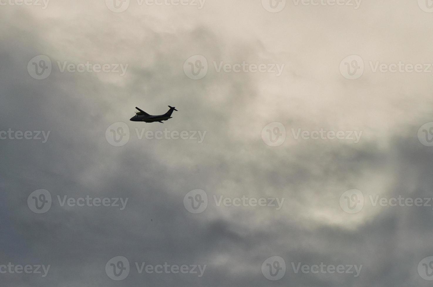 Plane in the evening sky in luminous horizon. It goes on vacation photo